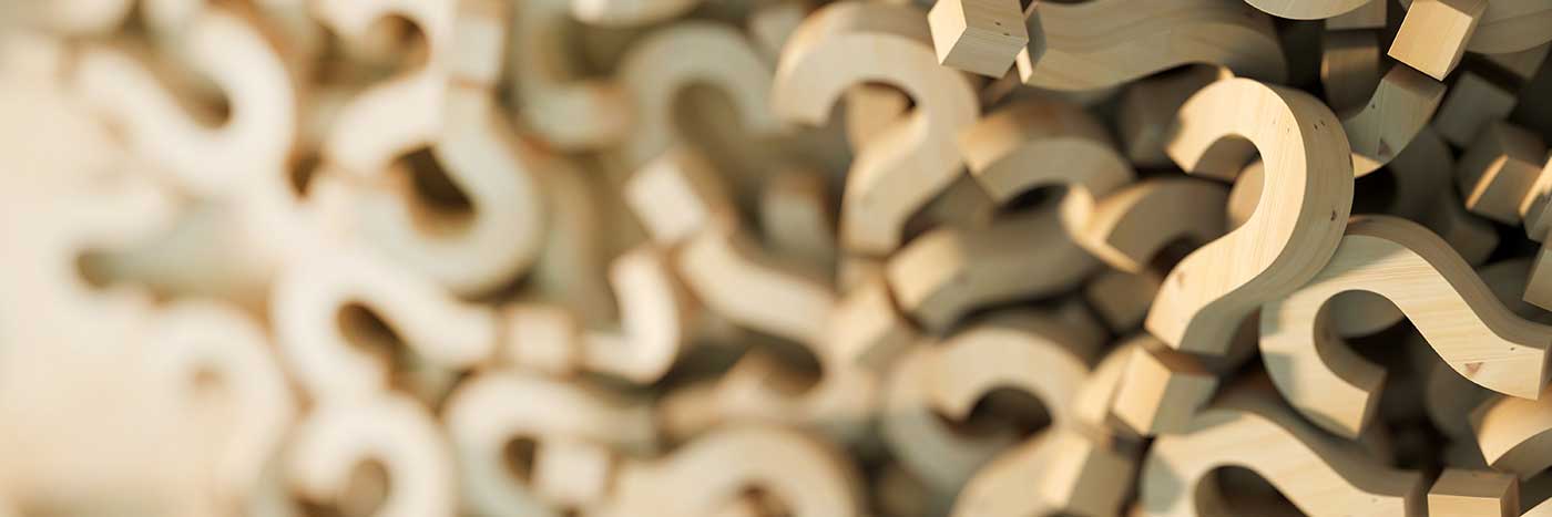 cropped image of a pile of wooden question marks